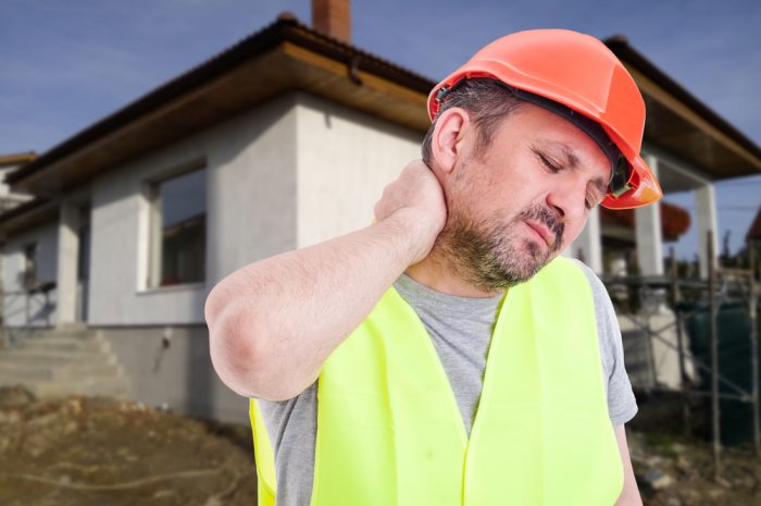 Male engineer or constructor with neck pain