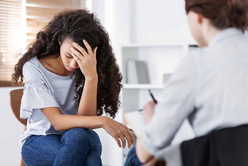 Professional psychotherapies and young woman suffering from stress