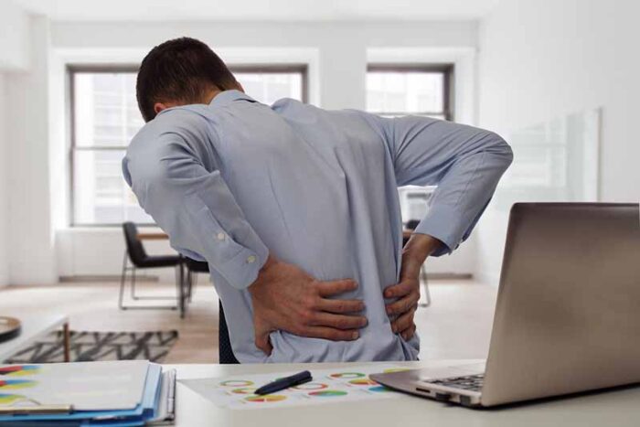 Business man with back pain in an office