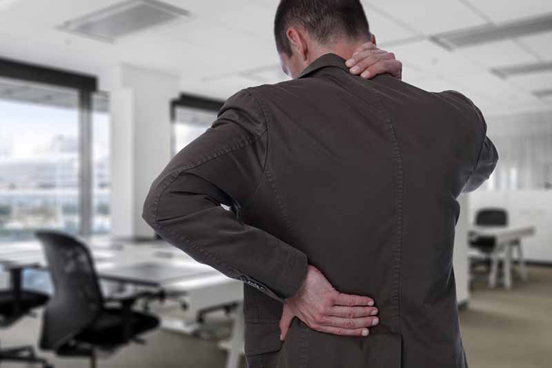 Business man with back pain in an office